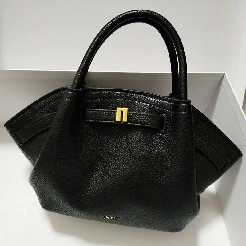 Professional styling of a leather crossbody bag for formal occasions